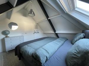 Tempat tidur dalam kamar di Vakantiehuis FijnDomein - vlak bij de Efteling