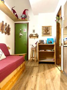 a bedroom with a bed and a green door at Piccolo Nido Falcade in Falcade