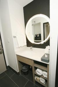 a bathroom with a sink and a mirror at La Quinta by Wyndham Des Moines West Clive in Clive