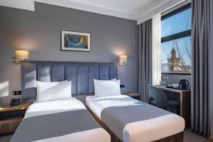 A bed or beds in a room at Barnovi Boutique Hotel