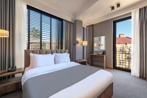 A bed or beds in a room at Barnovi Boutique Hotel