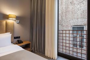 A bed or beds in a room at Barnovi Boutique Hotel