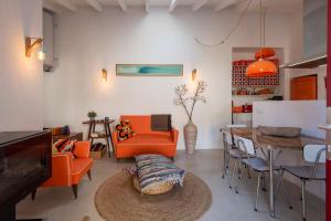 a living room with orange chairs and a table at Hillside 1 Aljezur old town in Aljezur