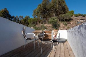 a table and chairs on a wooden deck at Hillside 1 Aljezur old town in Aljezur