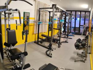 a gym with several rows of tread machines at Hotel Villa Costa in Celle Ligure