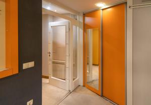 a hallway with orange walls and a mirror at Apartments Arna in Visoko +43 photos