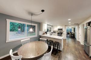 a kitchen and dining room with a wooden table and chairs at Woodinville Escape in Woodinville