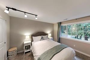a bedroom with a large bed and a window at Woodinville Escape in Woodinville