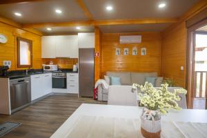 a kitchen and living room with a table and chairs at Recanto do Escalheiro in Vieira do Minho
