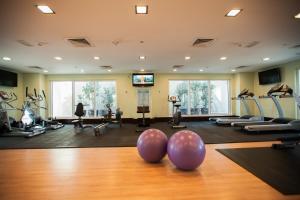 a gym with pilates equipment and people exercising at Citymax Hotel Al Barsha at the Mall in Dubai