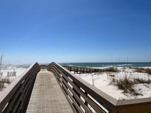 a boardwalk to the beach with the ocean in the background at Ole River Hideway, Orange Beach, Updated 2 Bedroom Waterfront Condo, Wind Drift in Orange Beach