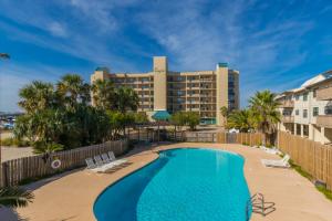 a pool with a hotel in the background at Ole River Hideway, Orange Beach, Updated 2 Bedroom Waterfront Condo, Wind Drift in Orange Beach