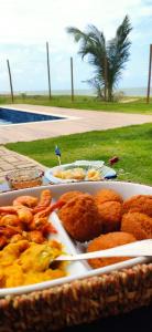 a tray of food with chicken tenders and shrimp at Pé na areia Itacimirim in Camacari