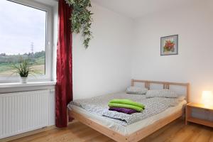 Un dormitorio con una cama con almohadas verdes. en Villa Apia, en Piwniczna-Zdrój