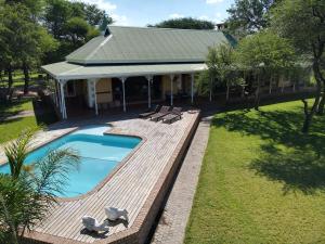 an overhead view of a backyard with a swimming pool and chairs at Ngangane Lodge & Reserve in Francistown
