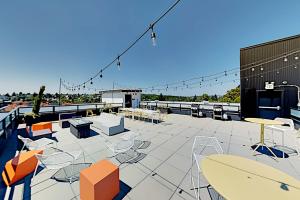 a patio with tables and chairs on a roof at Central Loft in Seattle