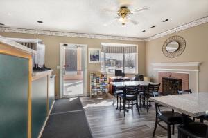 a kitchen and dining room with a table and chairs at Bardmoor Suites in Cedar City