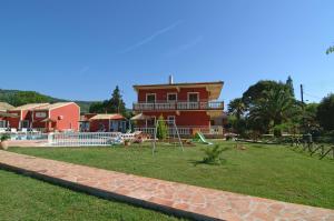 a house with a playground in front of a yard at Haroula Apartments in Sidari