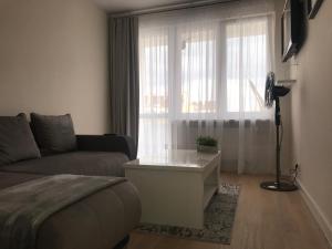 a living room with a couch and a window at Widok Kielce in Kielce