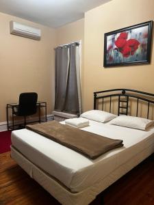 1 dormitorio con 1 cama y 1 silla en Adas Guesthouse en Toronto