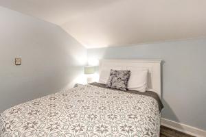 a bedroom with a bed with a pillow on it at Old Orchard Cottage in Old Orchard Beach