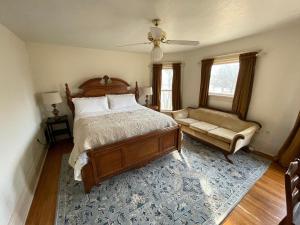 a bedroom with a large bed and a couch at Old Town Inn in Sioux Center
