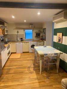 a kitchen with a table and a table and chairs at Mare&Focaccia in Genova