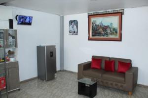 a living room with a couch and a picture on the wall at Muchick in Chiclayo