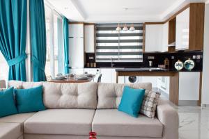 a living room with a couch and a kitchen at Four Seasons Life Rentals in Trikomo