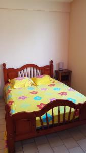 a bedroom with a bed with a colorful comforter at La Pause Randonnée de Grand'Rivière in Grandʼ Rivière