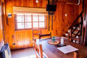 a dining room with a wooden table with a christmas tree on it at Doña Margarita in Chascomús