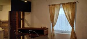 a room with a window with a dresser and a mirror at Apartment New Days in Sarajevo +28 photos