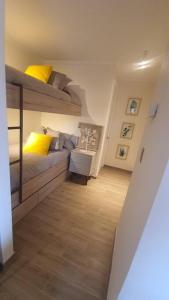 a bedroom with a bunk bed and a couch at Departamento Nuevo Pucón in Pucón +12 photos