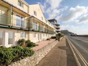 a building on the side of a road at 6 Lyme Mews in Seaton