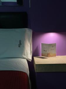 a bedroom with a bed with a book on it at Motel Las Dunas in Mexicali +3 photos