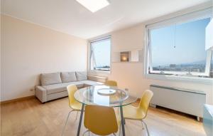 a living room with a glass table and chairs at Awesome Apartment In Genova With Wifi in Genova