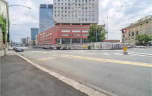 an empty city street with a red building at Awesome Apartment In Genova With Wifi in Genova