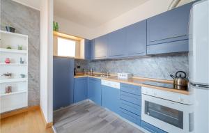 a kitchen with blue cabinets and a sink at Awesome Apartment In Genova With Wifi in Genova +19 photos