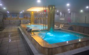 a large swimming pool in a building with a swimming pool at Daedunsan Hotel in Wanju