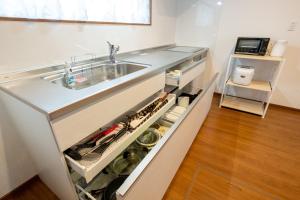 a kitchen with a sink and a counter at neige furano Vacation rented house in Furano