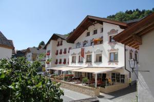 a large white building in a town with trees at Die Reblaus in Ladis