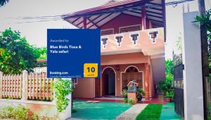 a house with a blue sign in front of it at Blue Birds Tissa & Yala safari in Tissamaharama