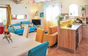 a kitchen and living room with a table and chairs at Amazing Home In Valréas With Wifi in Valréas