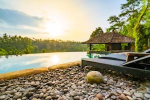 a resort with a pool and a house at Magatama Villa by Mahaputra in Gianyar