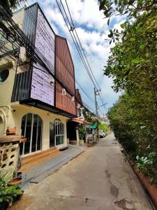 an empty street in front of a building at MiuMiu in da house. in Chiang Mai