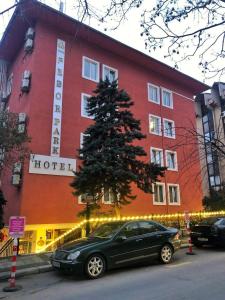 een auto geparkeerd voor een hotel met een kerstboom bij Febor Park İstanbul Levent Hotel in Istanbul