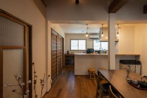 a kitchen and living room with a table and a counter at OMISHIMA SPACE Omoya in Imabari