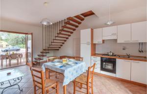 a kitchen and dining room with a table and chairs at 2 Bedroom Stunning Home In Straulas in San Teodoro