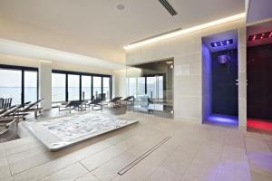 a lobby with a blue door and tables and chairs at Grand Hotel Terme Sirmione in Sirmione