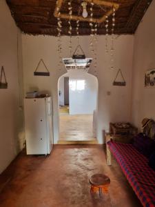 a room with a refrigerator and a table in it at Sunny House Paje in Paje